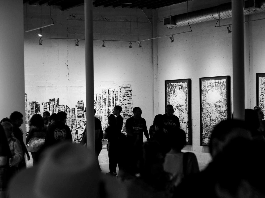 A crowded exhibition opening photographed in black and white