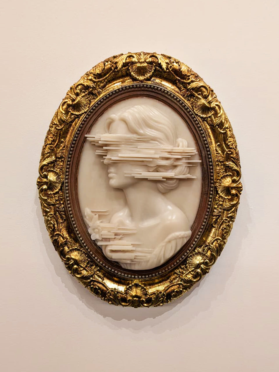 Anne Brontë Cameo — resin and 24k gold leaf by JoCa: an ivory cameo profile whose face breaks into horizontal glitch layers, in an ornate gold oval frame