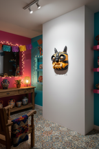 Tigre artwork at three-quarter angle in Mexican kitsch living room at night