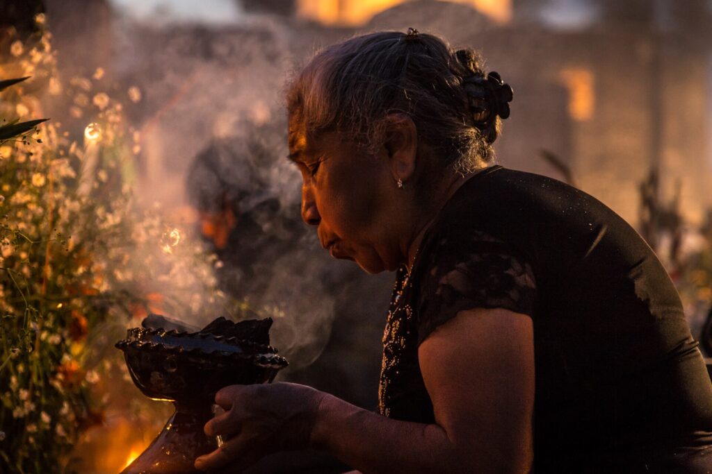 A woman with copal incense during the Day of the Dead night vigil in San Andrés Mixquic, 2014